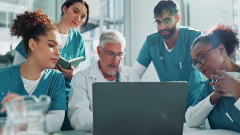 medical team collaborating on patient care using a laptop