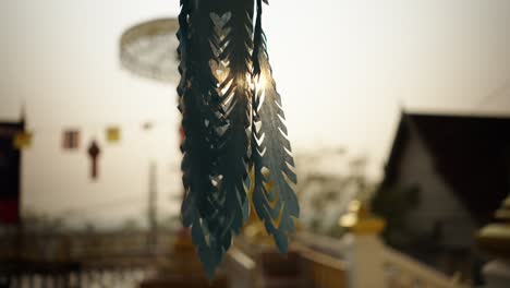 ornate lantern hanging at a thai temple