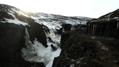 Iceland's-icy-mountains-are-covered-in-huge-blankets-of-white,-like-a-bird-flying-over