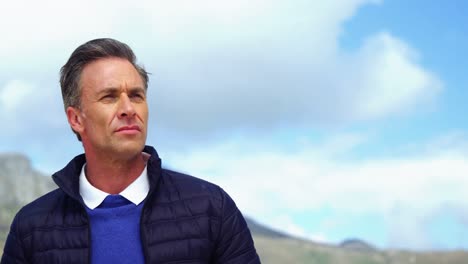 mature man standing on beach