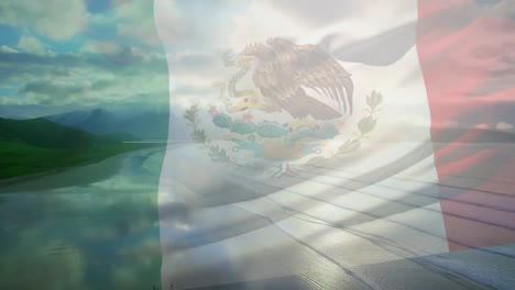 Digital-composition-of-waving-mexico-flag-against-aerial-view-of-the-beach-and-sea-waves