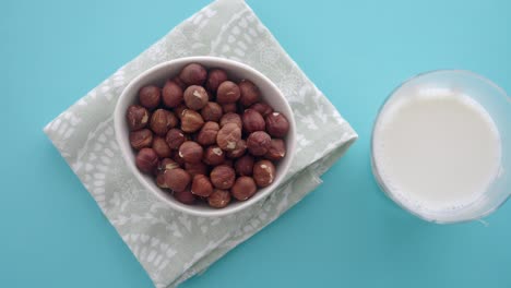 bowl of hazelnuts and a glass of milk