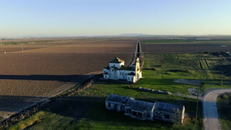 drone footage of the hermitage of la señuela showing the surrounding agricultural landscape