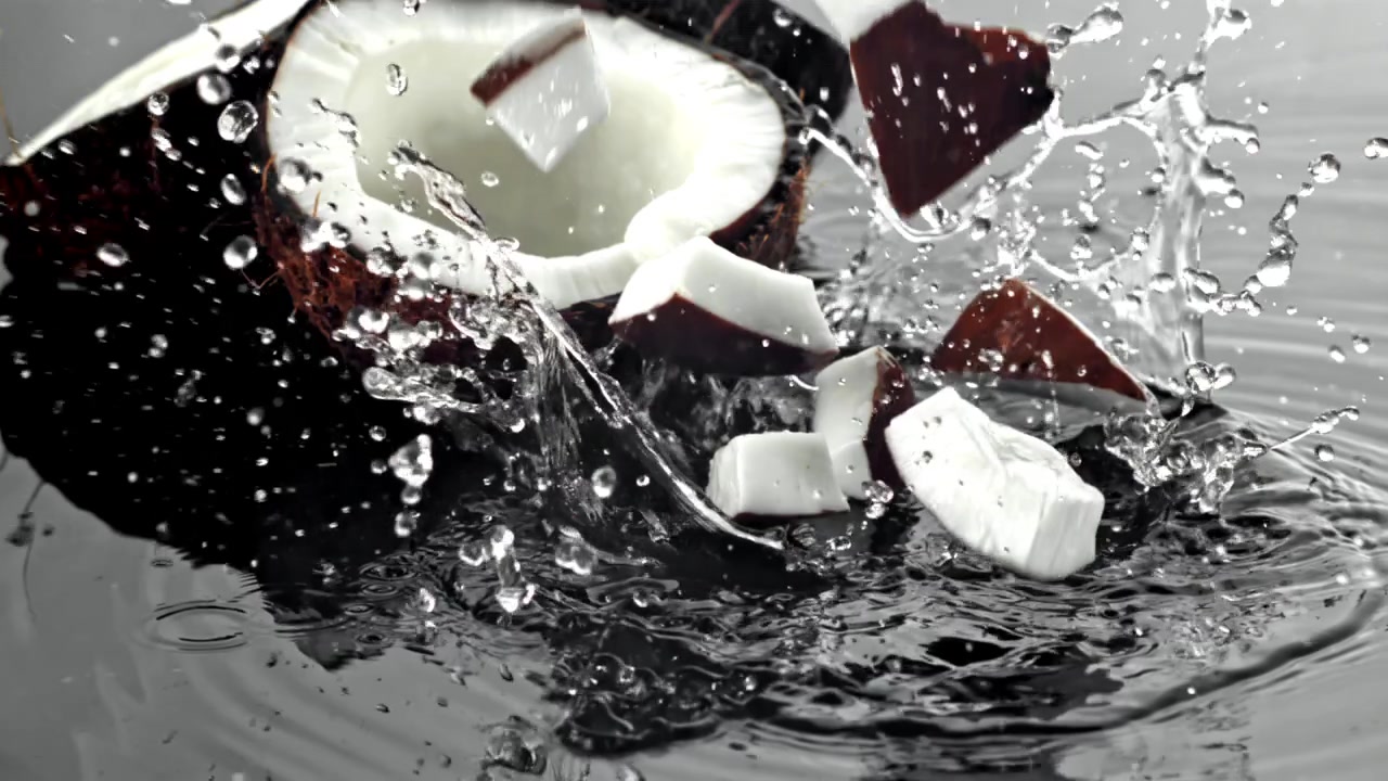 Coconut Pieces Splashing into Water in Slow Motion