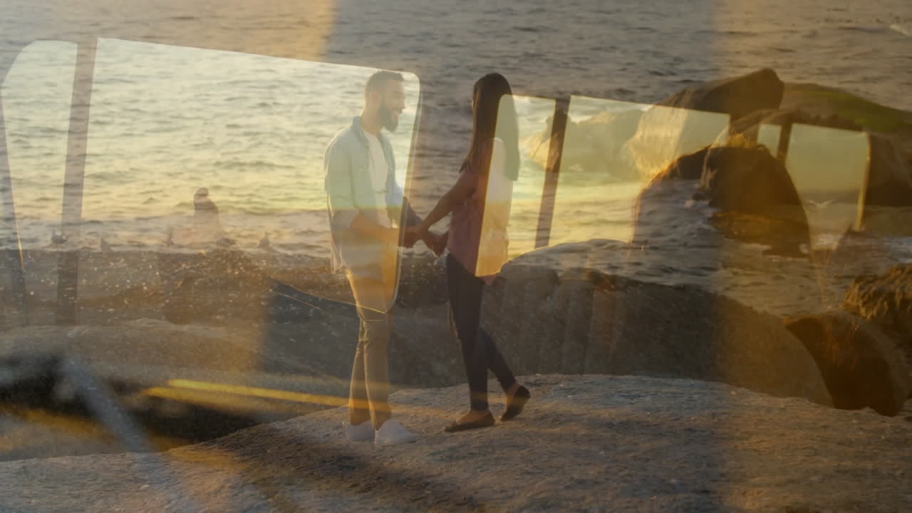 Holding hands on beach, couple watching sunset with ocean waves animation