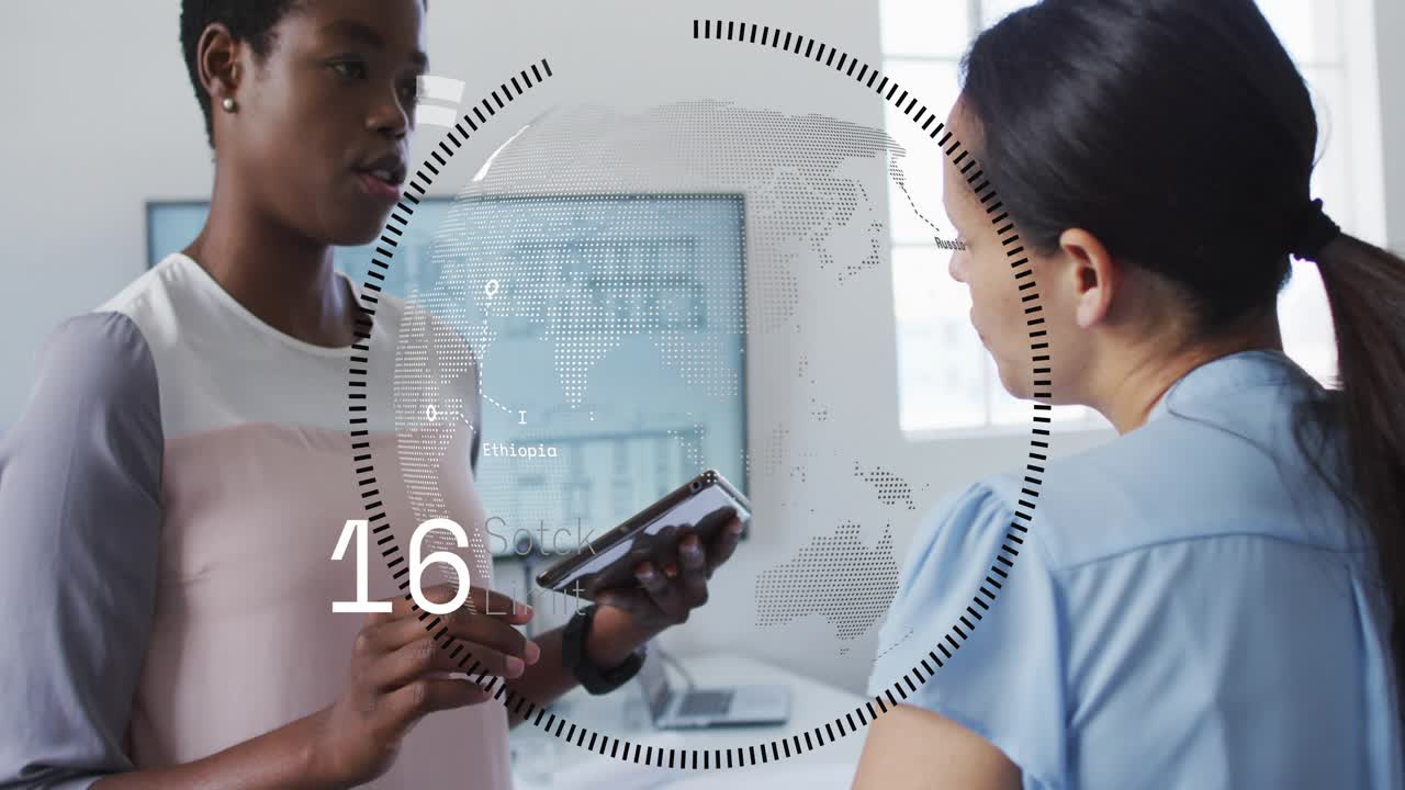 Left woman tapping tablet, right woman leaning, HUD animating readouts rising falling for business