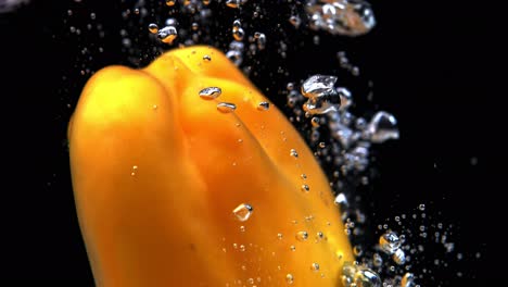 yellow bell pepper splashing underwater