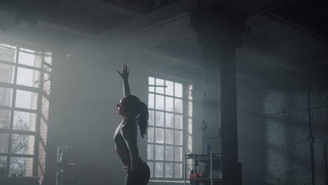 woman preparing for workout in gym. girl stretching body before training