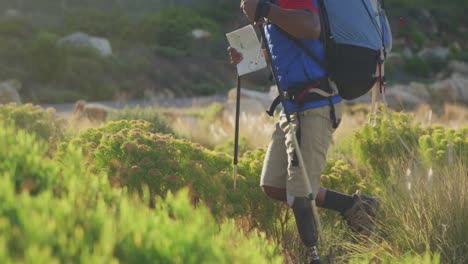 mixed race man with prosthetic leg hiking in nature