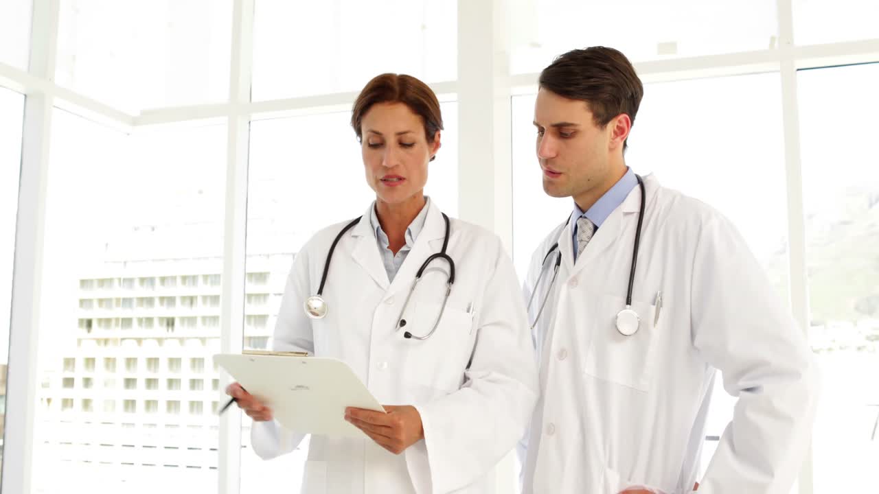 Premium stock video - Doctors speaking about a file