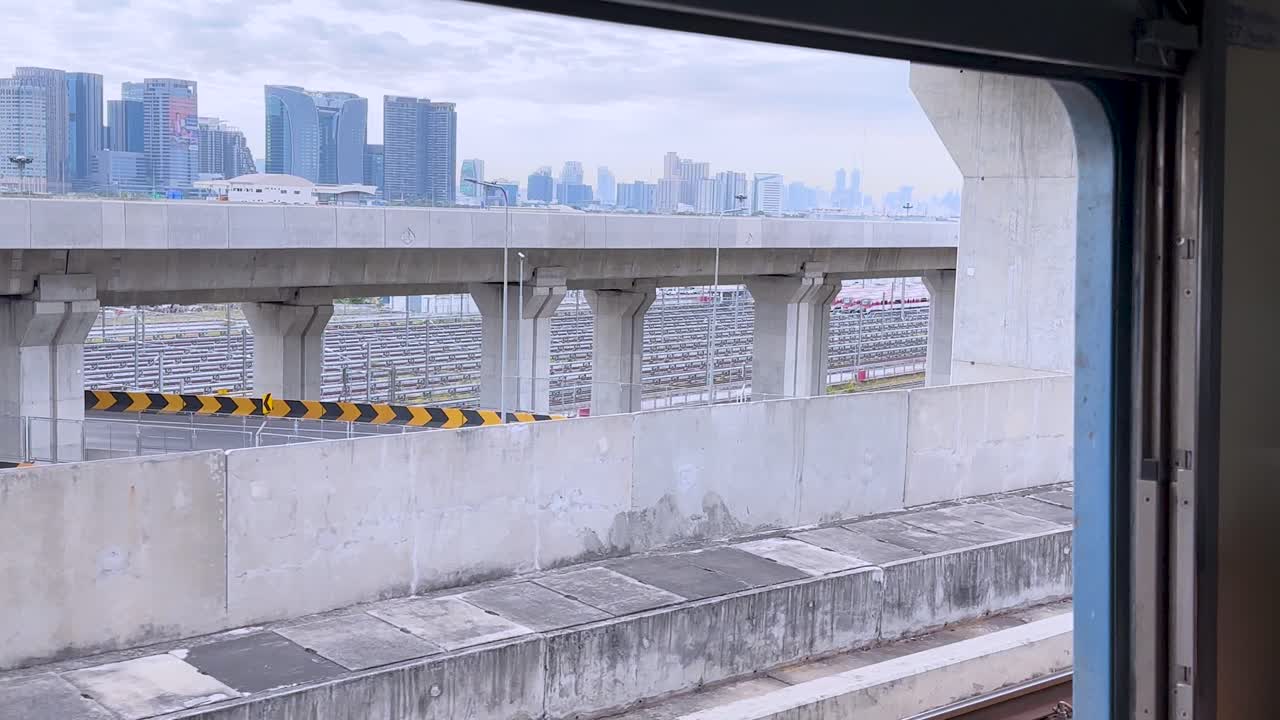 View of city skyline and train tracks from a train window