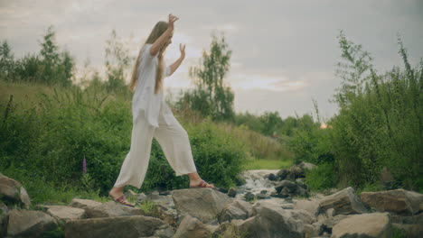 Woman-Crossing-Stream-In-Mountains