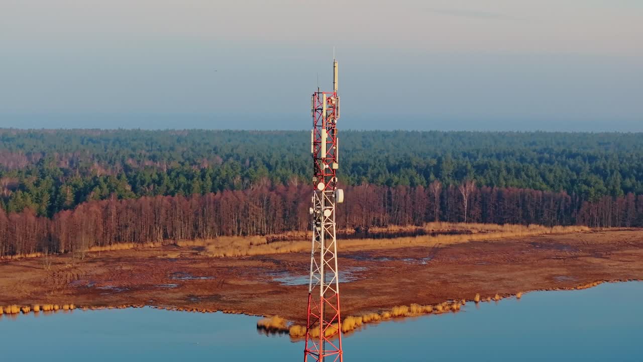 Drone captures rotating view of signal tower standing tall over Buļļupe, sunrise