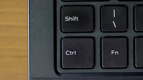 finger pushing shift keyboard button top view