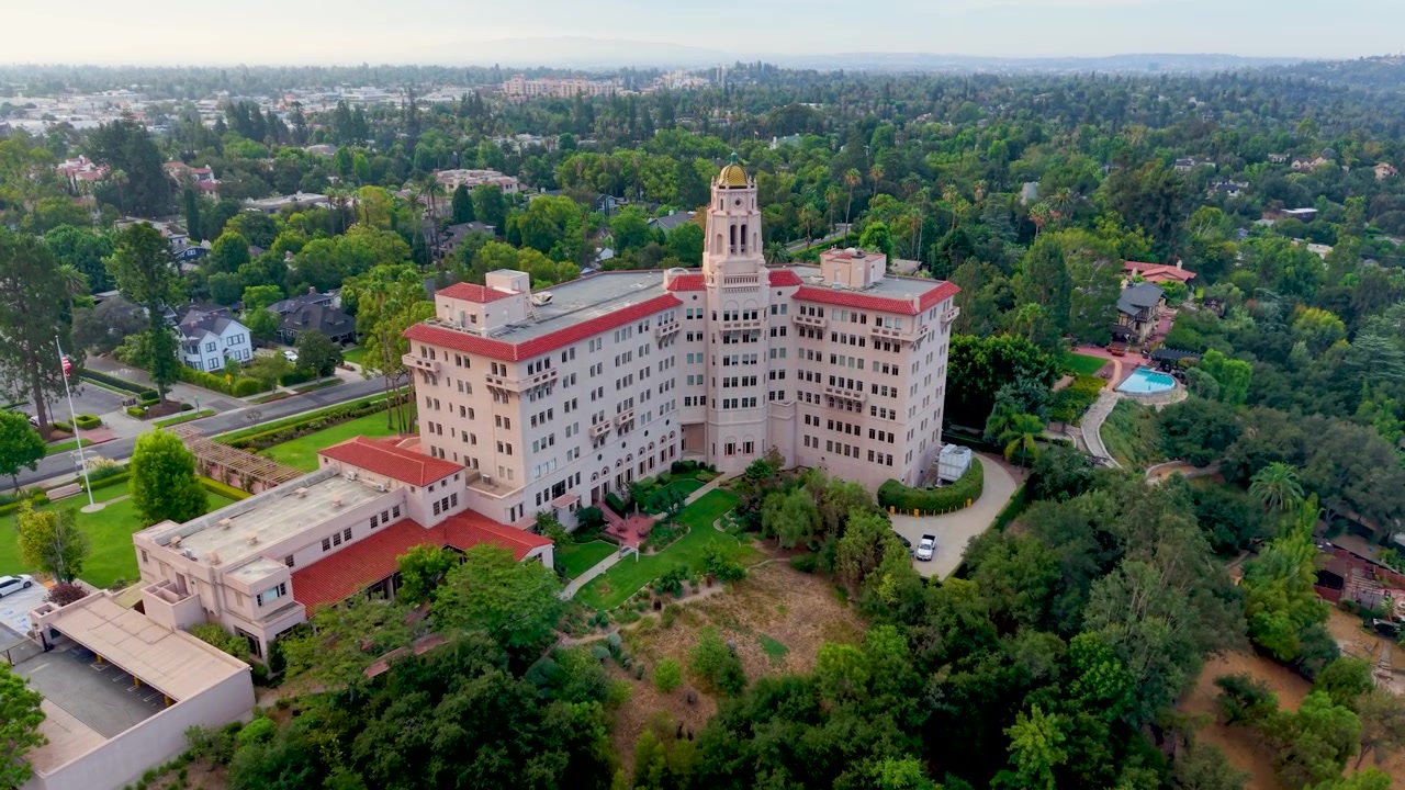 The Drone slowly rises into the sky with a full view of the Historic Courthouse. Cinematic Aerial Shot shows the beauty in the Architecture of this Iconic Los Angeles Landmark among Lush Green Trees