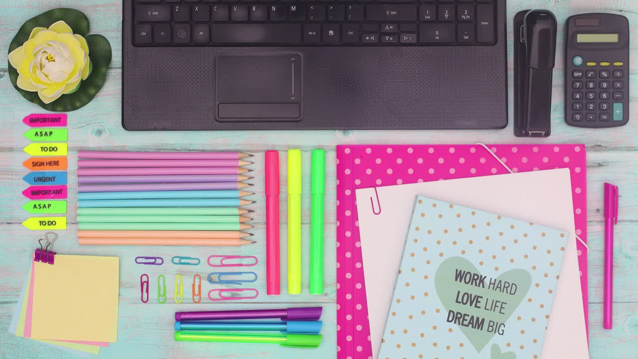 School and office supplies moving around lap top. Stop motion