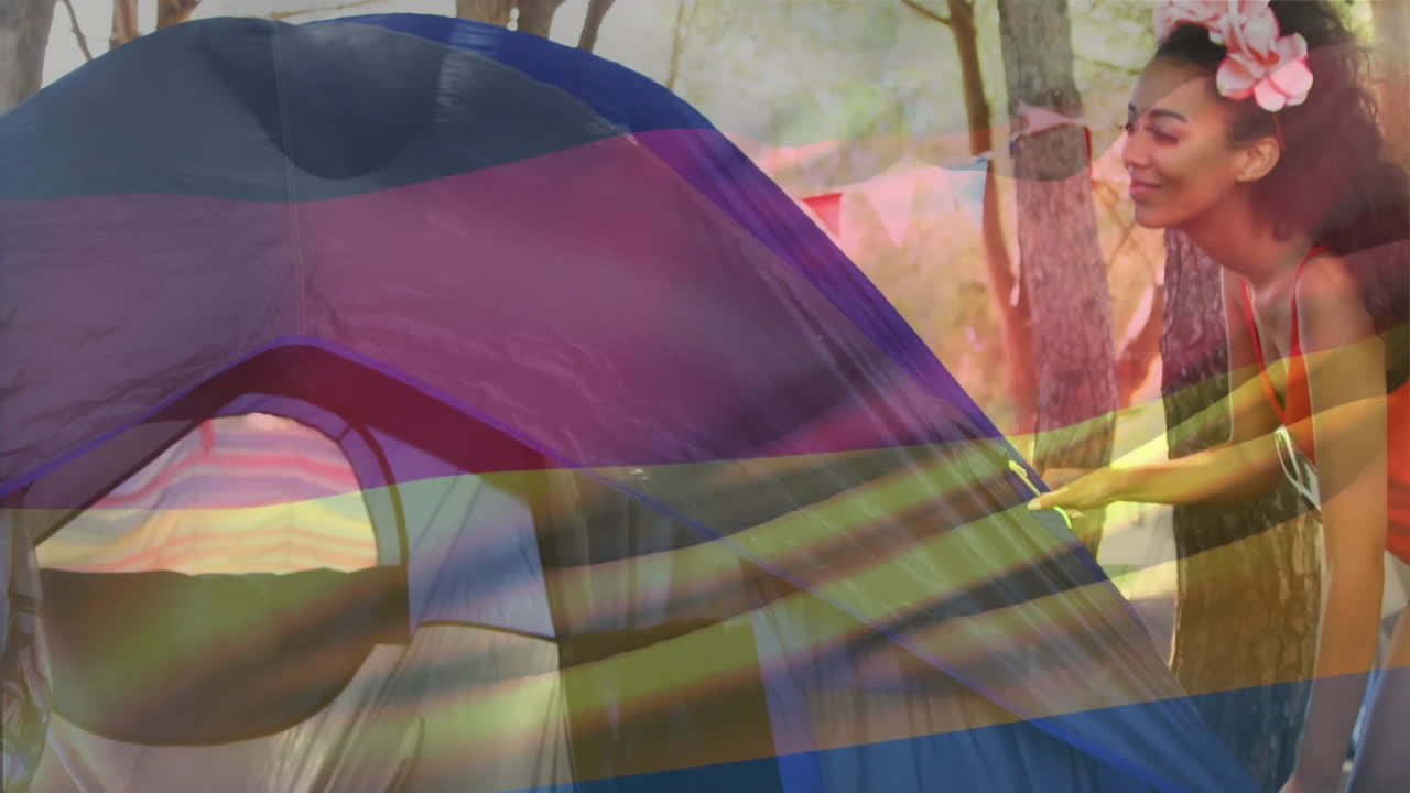 animación de la bandera alemana sobre la gente montando una tienda en el bosque