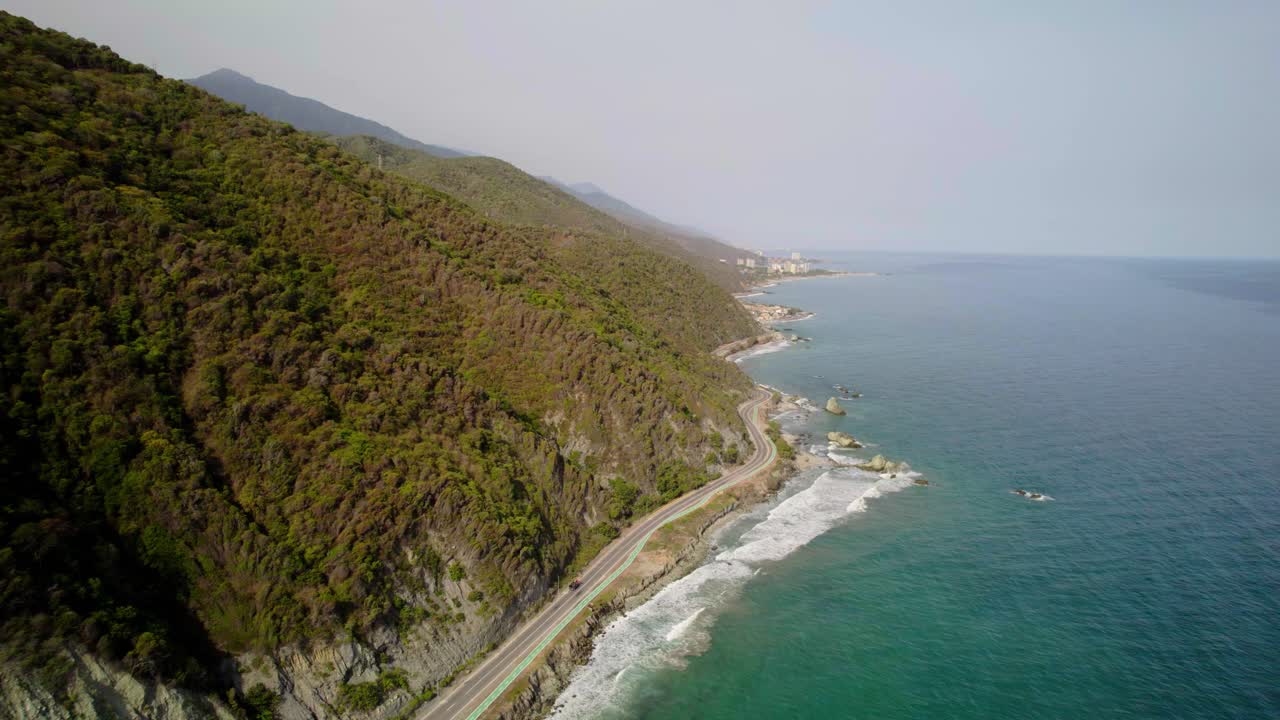 Winding coastal road along lush mountains and the blue ocean in Naiguata, Venezuela
