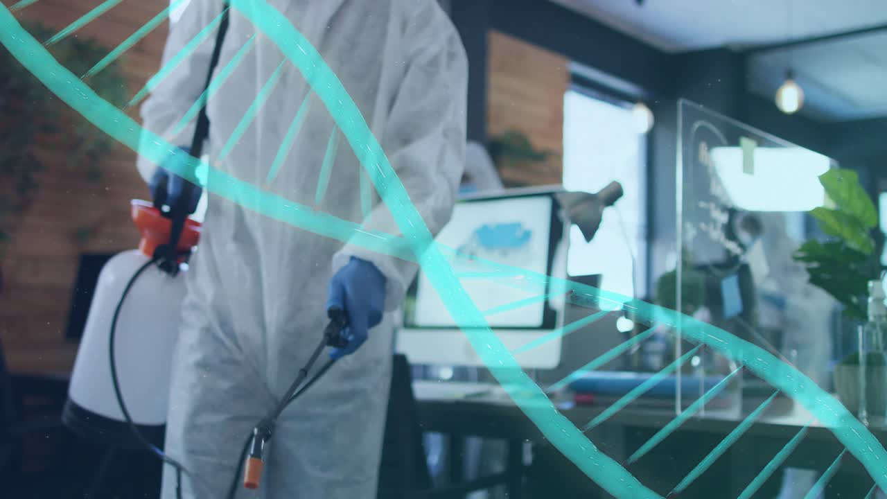 Worker entering left in PPE, spraying desk and plexiglass for office cleaning, teal helix crossing