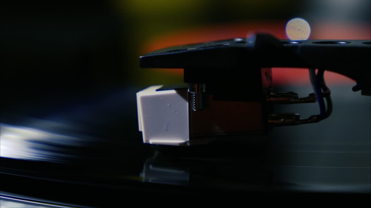 Closeup needle on spinning vintage vinyl record on turntable
