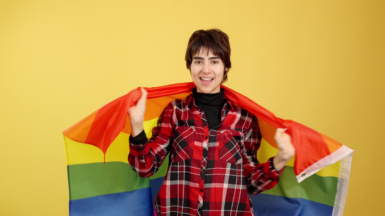 Smiling Person Wrapped in a Rainbow Pride Flag