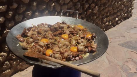 sizzling hearty breakfast stir-fry with chicken and eggs in a huge wok