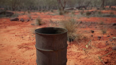 old empty rusted barrel on sand