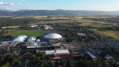 drone view of montana state university campus in bozeman, montana. drone flies in straight line.