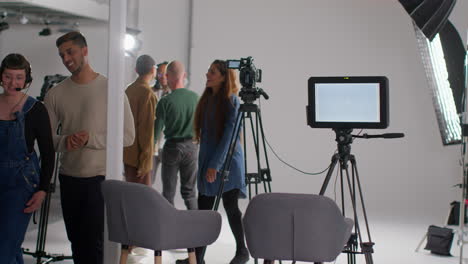 Film-Crew-And-Female-Director-Congratulating-Actors-After-Performance-Shooting-Movie-Or-Video-In-Studio-4