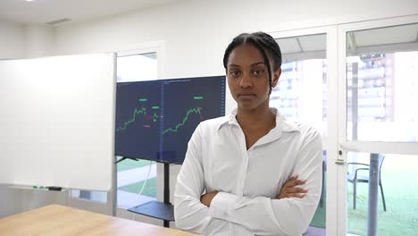 black african business woman looking at camera with a trading view graphic in the background serious face expression