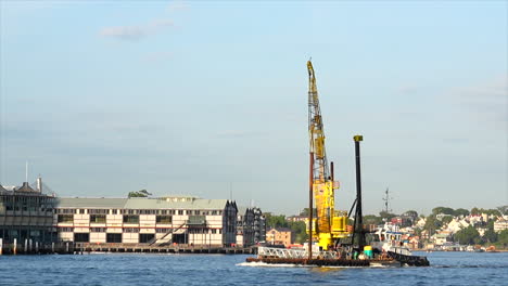 a construction crane ship passes by in sydney harbour australia