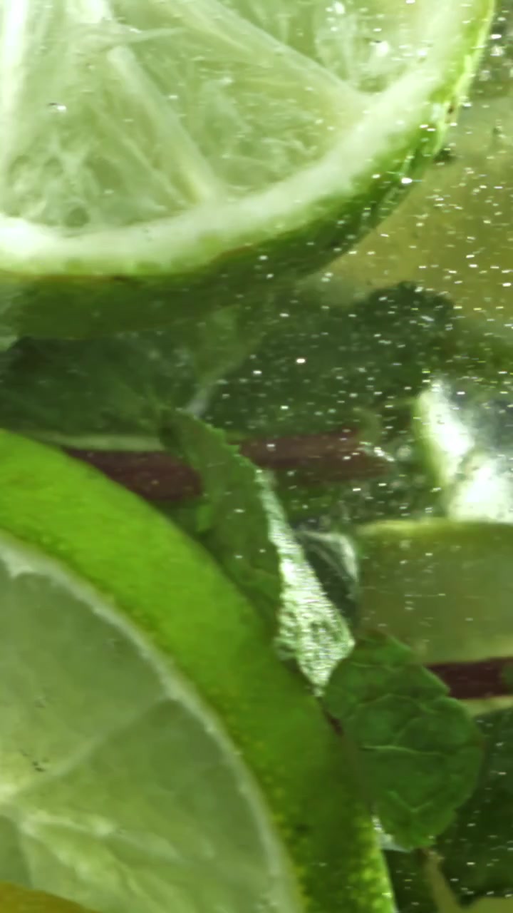 Primo piano di lime e menta rinfrescanti in acqua frizzante