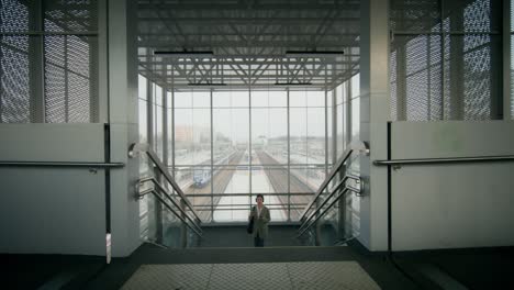 woman walking through a modern train station