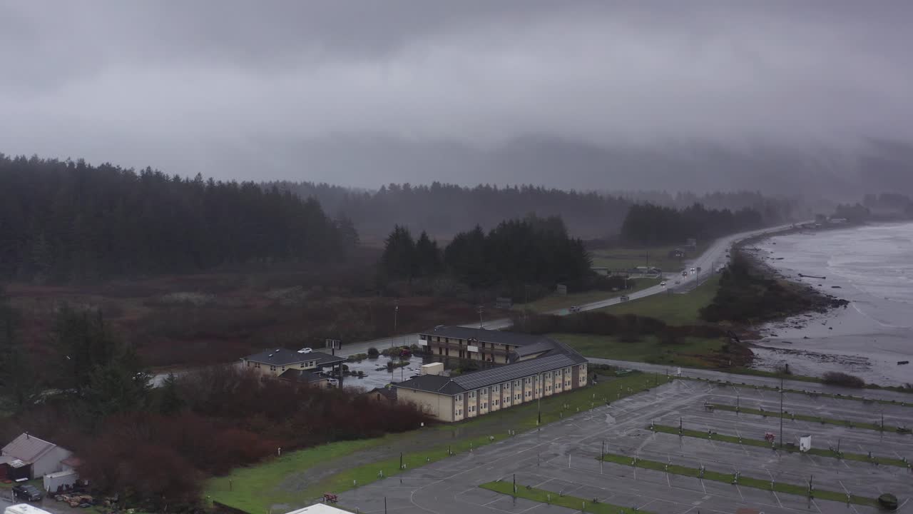Aerial low push-in shot of a motel in Crescent City during stormy weather in Northern California. 4K