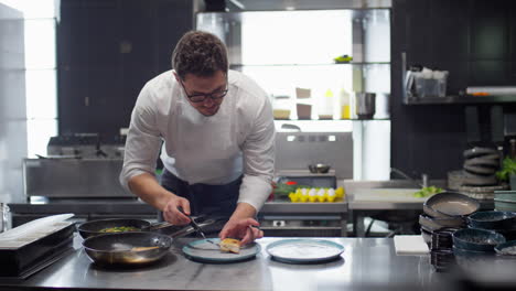 chef serving cooked fish on plates