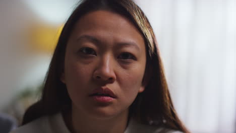 Close-Up-Portrait-Of-Stressed-Or-Anxious-Woman-Suffering-With-Depression-Anxiety-Or-Loneliness-Sitting-In-Room-At-Home