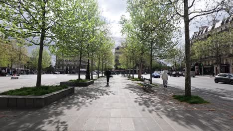 a person walks across a city park plaza