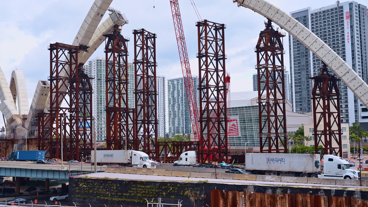 Miami, USA, 6 April 2026: Steel support structures for bridge arch construction in Miami. Close up of red steel temporary supports and concrete arch segments during a major infrastructure project