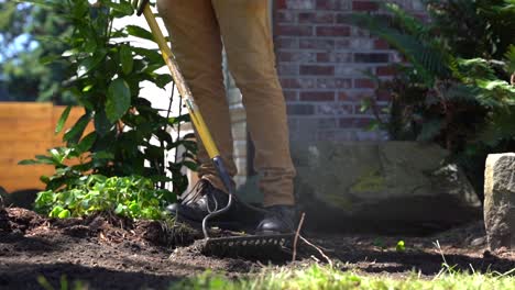 Landscaper-Raking-Dirt-in-Yard---Slow-Motion