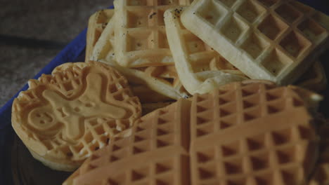 close up shot of a variety of steaming belgian waffles without toppings