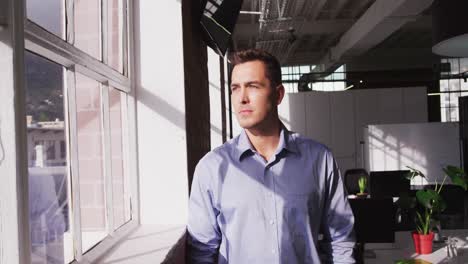 portrait of caucasian businessman looking ahead then shifting gaze to camera and smiling