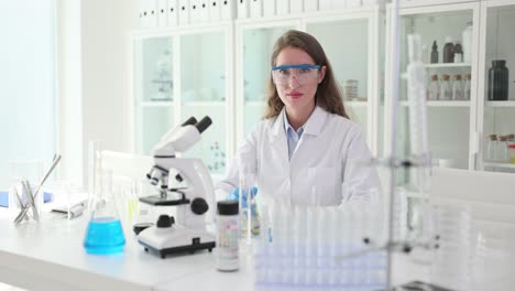 female scientist giving thumbs up in laboratory