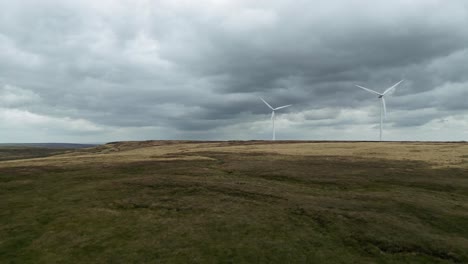 drone aerial view of a wind farm and wind turbines turning in the wind-1