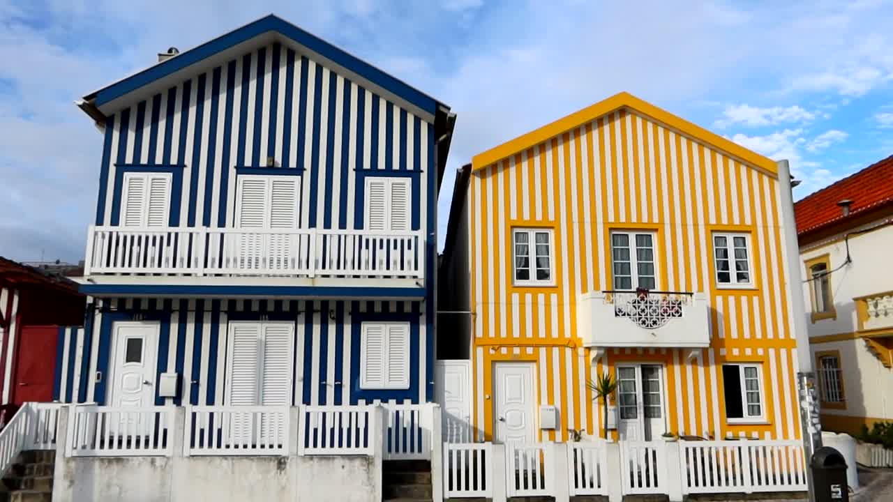 una foto inclinada hacia abajo de dos casas despojadas y coloridas en costa nova, portugal
