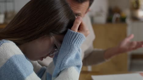 caucasian man screaming at his teenage girl who seems broken