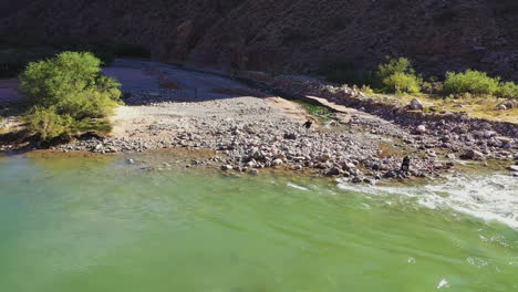 An-aerial-shot-of-a-campsite-by-the-Colorado-river-where-many-attend-for-photos