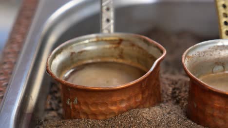 turkish coffee being brewed in a copper pot