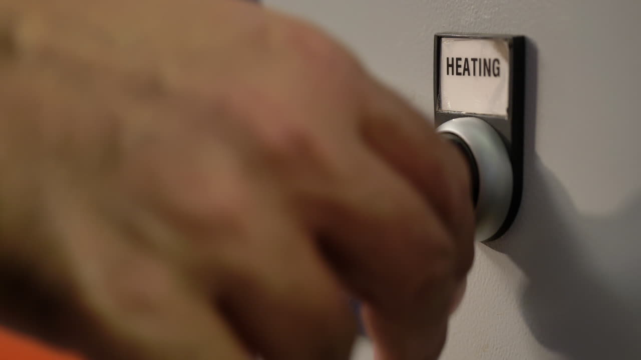 Closeup Of A Hand Turning A Industrial Heating Switch In A Factory, Industrial Heater