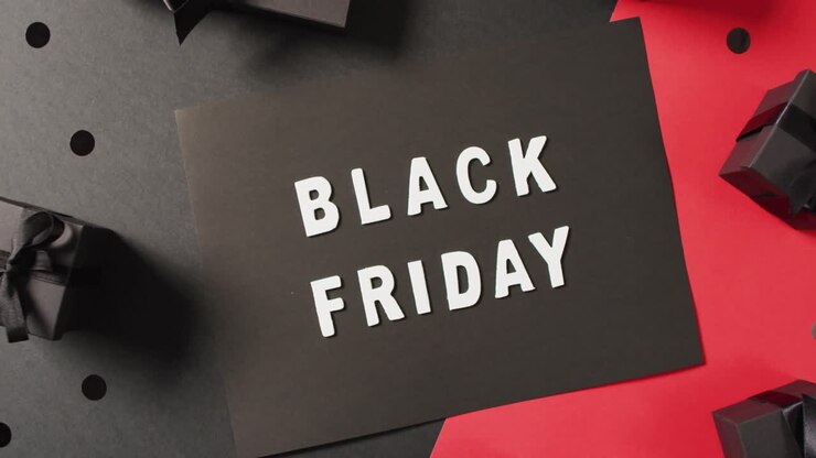 Black friday text in white on black with black gift boxes on red and black background