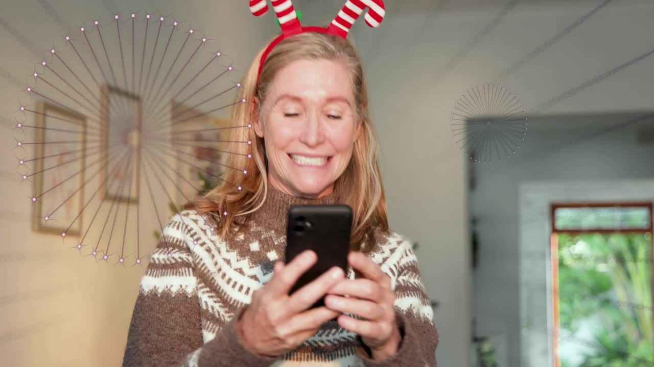 Woman receiving phone call and adjusting holiday tree decor while tapping screen creating posts